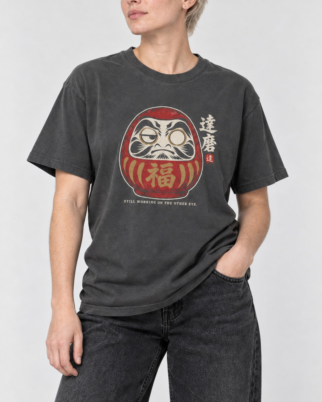 Still Working on the Other Eye Daruma T-Shirt in Pepper, close-up