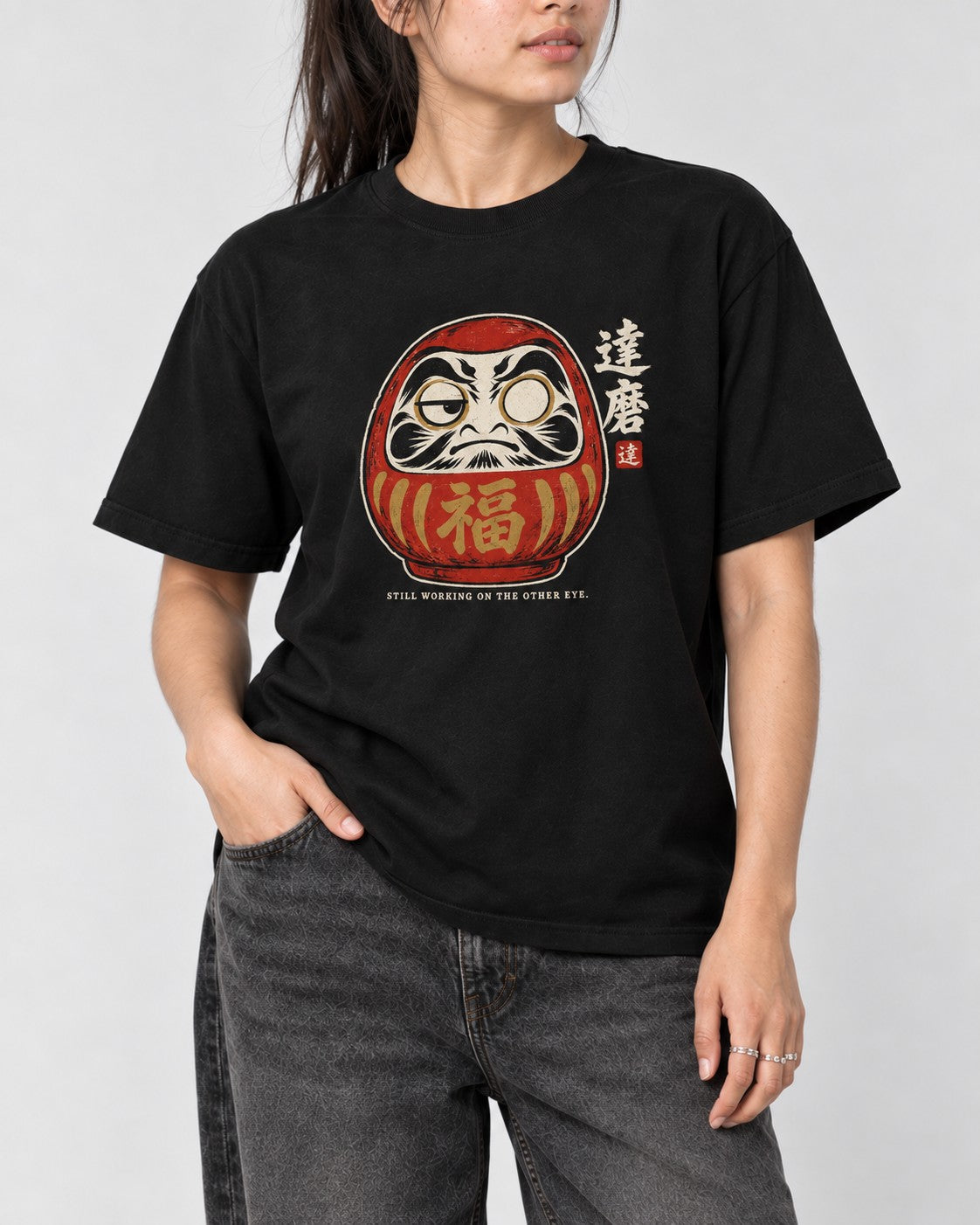 Still Working on the Other Eye Daruma T-Shirt in Black, close-up
